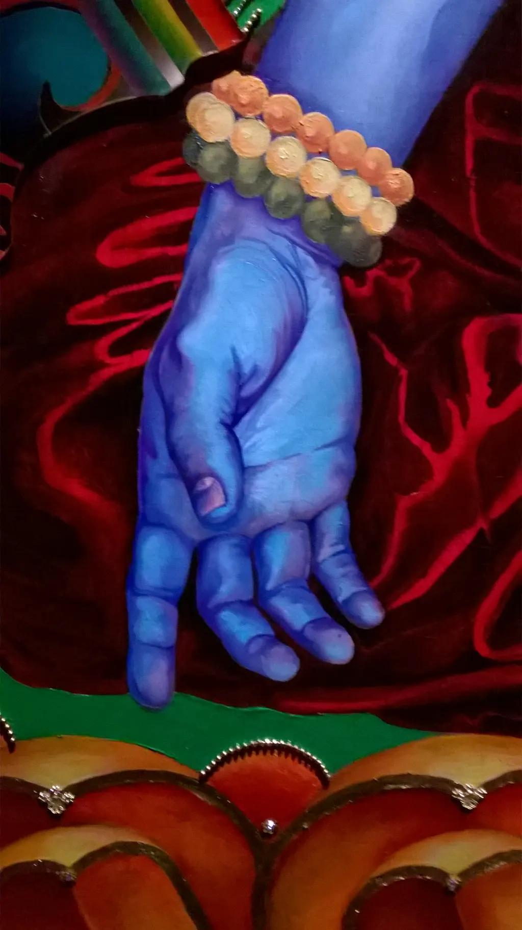 Detail: the Buddha's blue hand and prayer beads